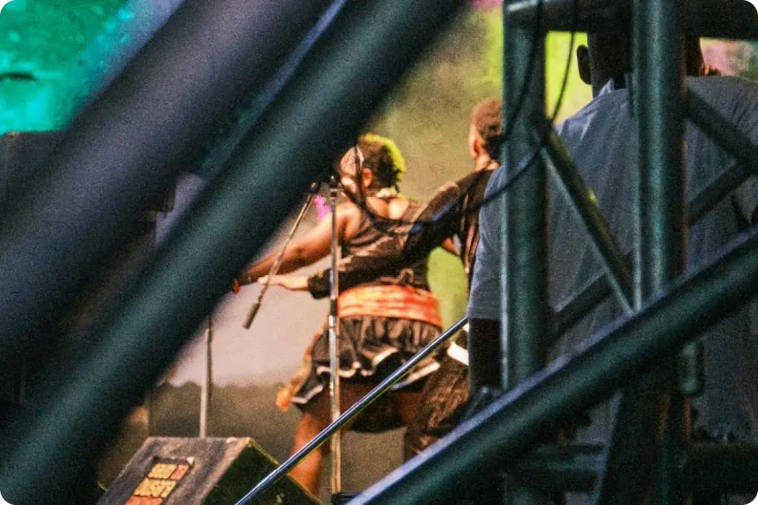 Performers on a darkened festival stage