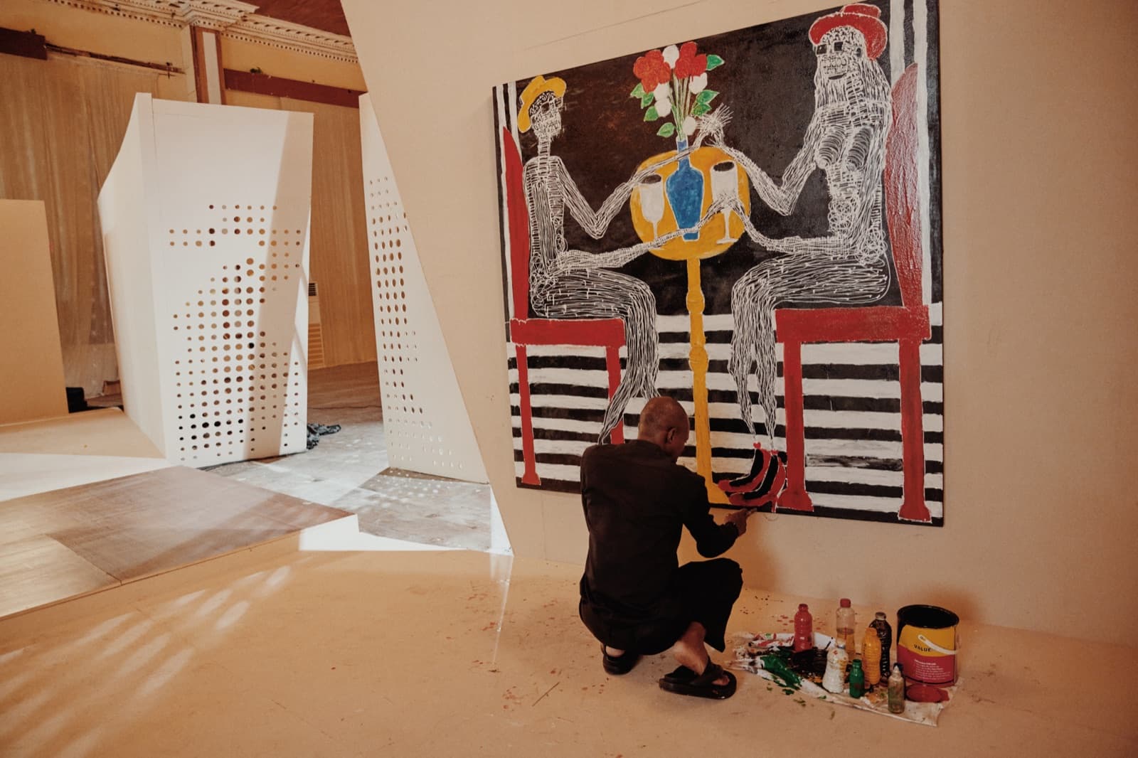 Artist at work on a large painting